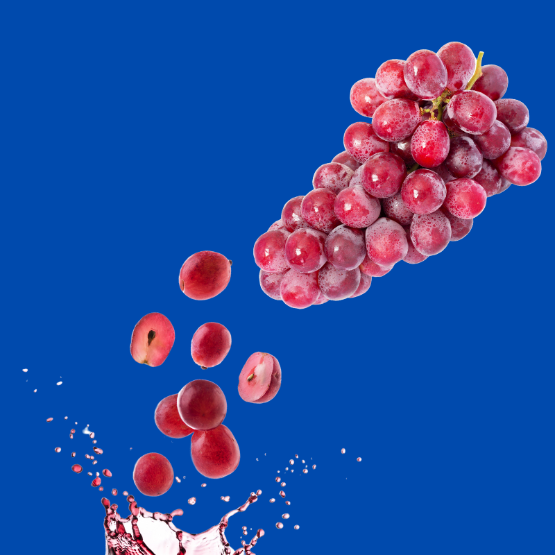 Fresh grapes on a blue background representing Hypothermias Dye-FREE Grape Shaved Ice Syrup, made with pure cane sugar and no corn syrup, small-batch crafted in Tucson, AZ.