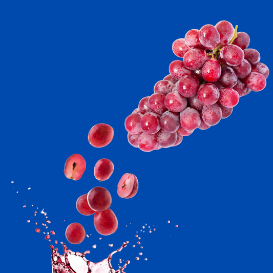 Fresh grapes on a blue background representing Hypothermias Dye-FREE Grape Shaved Ice Syrup, made with pure cane sugar and no corn syrup, small-batch crafted in Tucson, AZ.